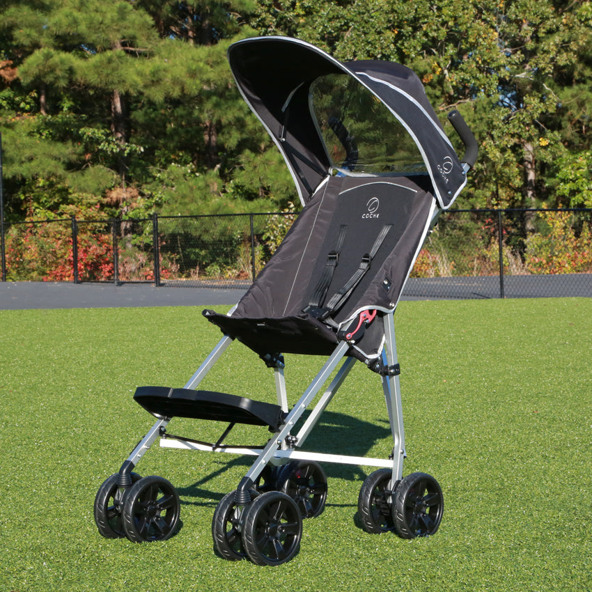 Black Coche XL sunshade canopy installed on the stroller outdoors